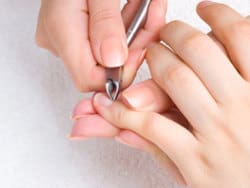 nail salon - cuticle cut on the female little finger